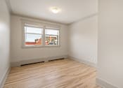 Thumbnail 110 of 219 - Empty room with wooden floor and white walls.