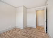 Thumbnail 109 of 219 - A room with a wooden floor and white walls.