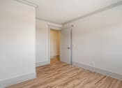 Thumbnail 108 of 219 - A room with a wooden floor and white walls.