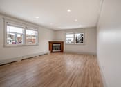 Thumbnail 98 of 219 - A room with wooden floors and a fireplace.