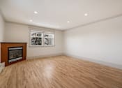 Thumbnail 116 of 219 - A room with a wood floor and a fireplace.