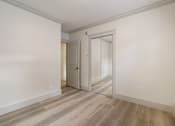 Thumbnail 86 of 219 - A room with a white wall and a wooden floor.