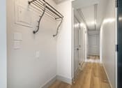 Thumbnail 76 of 219 - A long hallway with a towel rack on the wall.
