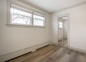 Thumbnail 95 of 219 - A room with a white wall and a wooden floor.