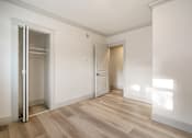 Thumbnail 93 of 219 - A room with a wooden floor and white walls.