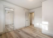 Thumbnail 92 of 219 - A room with a wooden floor and a sliding glass door.