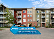 Thumbnail 1 of 31 - A building with a sign offering a 13th month free with a 13 month lease and 3 months free parking with a 13 month lease.