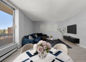 Thumbnail 6 of 33 - a living room with a table with a vase of flowers on it