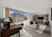 Thumbnail 9 of 33 - a living room with a white couch and a large window