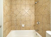 Thumbnail 143 of 219 - A bathroom with a tiled shower and a bathtub.