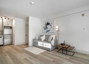 Thumbnail 154 of 219 - A modern living room with a grey couch and a coffee table.