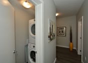 Thumbnail 19 of 42 - A white washer and dryer in a small room.