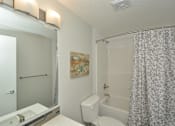 Thumbnail 16 of 42 - A bathroom with a toilet, sink, and shower.