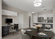 Thumbnail 4 of 72 - a dining room and kitchen with a table and chairs and a tv