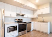 Thumbnail 21 of 35 - Fully Furnished Kitchen at All Saints Apartments, Colorado