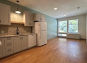 Thumbnail 11 of 34 - A kitchen with wooden floors and white appliances.at Benedict, The, GLENWOOD SPRINGS, CO