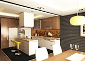 Thumbnail 1 of 11 - A modern kitchen with a wooden table and white chairs.