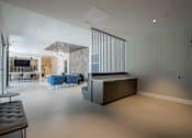 Thumbnail 7 of 66 - Lobby view at The Rail with seating and divider wall, highlighting design-forward amenity space in this luxury pet-friendly apartment community.