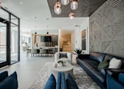 Thumbnail 2 of 66 - Elegant lobby area with bold accent wall, artistic lighting, and comfortable seating—modern design meets comfort at The Rail Bound Brook.