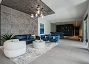 Thumbnail 6 of 66 - Lobby view at The Rail with seating and divider wall, highlighting design-forward amenity space in this luxury pet-friendly apartment community.