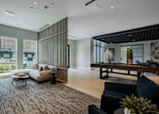 Thumbnail 54 of 66 - Modern resident lounge at The Rail at Bound Brook featuring natural light, plush seating, and views of the outdoor courtyard.