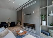 Thumbnail 55 of 66 - Cozy lounge nook with modern fireplace and built-in shelving inside The Rail at Bound Brook’s game room.