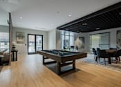 Thumbnail 49 of 66 - Spacious game room at The Rail at Bound Brook showcasing contemporary design, billiards table, and direct courtyard access.