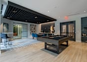 Thumbnail 50 of 66 - Stylish resident lounge at The Rail at Bound Brook featuring a pool table, dining space, and modern design.