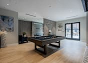 Thumbnail 51 of 66 - Sophisticated clubroom at The Rail at Bound Brook with billiards, modern furniture, and built-in fireplace.