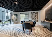 Thumbnail 48 of 66 - Resident lounge at The Rail featuring a large wooden dining table, designer lighting, and floor-to-ceiling windows.