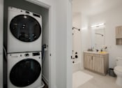 Thumbnail 28 of 66 - Modern apartment bathroom and in-unit laundry at The Rail in Bound Brook, NJ—complete with stackable washer/dryer, luxury finishes, and resident perks for comfortable living.