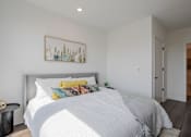 Thumbnail 25 of 66 - Interior bedroom photo from The Rail at Bound Brook showcasing high-end finishes, a walk-in closet, and modern apartment design near commuter-friendly transit access.