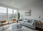 Thumbnail 21 of 66 - Contemporary living space at The Rail with modern furnishings, large rug, and natural finishes—ideal for urban lifestyle near NJ Transit.