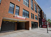 Thumbnail 66 of 66 - Street-level image of The Rail at Bound Brook luxury apartments with visible garage entrance.