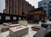 Thumbnail 15 of 72 - Stylish outdoor seating and fire pits at The Rail at Bound Brook’s landscaped courtyard—highlighting upscale apartment living in Bound Brook, NJ.