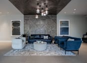 Thumbnail 1 of 33 - A luxury modern apartment lobby with a blue couch at The Rail at Bound Brook, NJ.