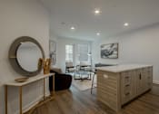 Thumbnail 15 of 33 - Open-concept living room and kitchen area in a luxury apartment at The Rail at Bound Brook, NJ.