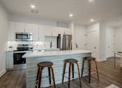 Thumbnail 12 of 33 - Spacious kitchen island and barstool seating in a luxury apartment at The Rail at Bound Brook, NJ.