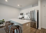 Thumbnail 13 of 33 - Luxury kitchen island and barstool seating in a luxury apartment at The Rail at Bound Brook, NJ.