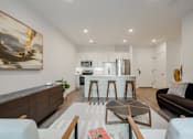 Thumbnail 6 of 33 - Luxury pet-friendly apartment living room with modern furnishings and natural light at The Rail at Bound Brook, NJ.