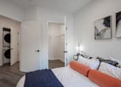 Thumbnail 21 of 33 - Luxury apartment bedroom with walk-in closet and in-unit washer and dryer at The Rail at Bound Brook, NJ.