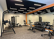 Thumbnail 59 of 66 - Modern fitness center at The Rail at Bound Brook featuring open space, natural light, and top-tier workout amenities for luxury apartment residents near NJ Transit.