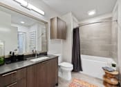 Thumbnail 3 of 18 - a bathroom with a sink toilet and bathtub