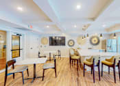 Thumbnail 28 of 102 - A dining room with a white table and chairs.
