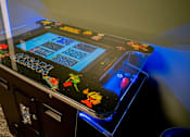 Thumbnail 32 of 102 - A pinball machine with a black background and colorful designs.