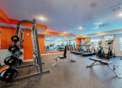 Thumbnail 35 of 102 - A gym with a variety of equipment including weights and cardio machines.