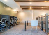 Thumbnail 57 of 102 - A conference room with a white table and chairs.