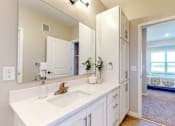 Thumbnail 62 of 102 - A bathroom with a white sink and mirror.