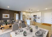 Thumbnail 75 of 102 - A modern dining room with a wooden table set for two.
