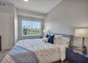 Thumbnail 9 of 98 - A bedroom with a large bed and a window with blinds.